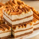 Churro cheesecake bars with a golden, cinnamon-sugar topping and creamy filling