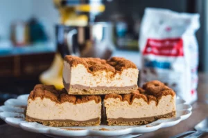 Churro cheesecake bars with a golden, cinnamon-sugar topping and creamy filling